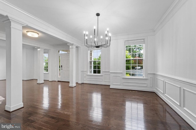 unfurnished dining area featuring dark hardwood / wood-style floors, ornamental molding, and an inviting chandelier