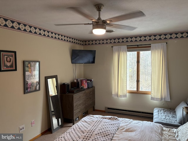 bedroom featuring ceiling fan and a baseboard radiator