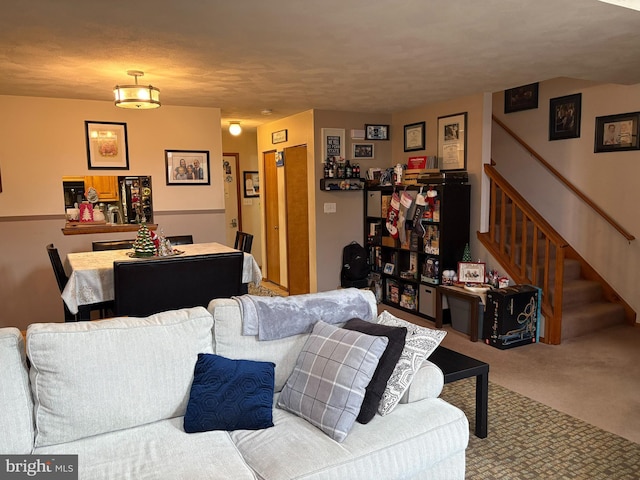 carpeted living room featuring a textured ceiling