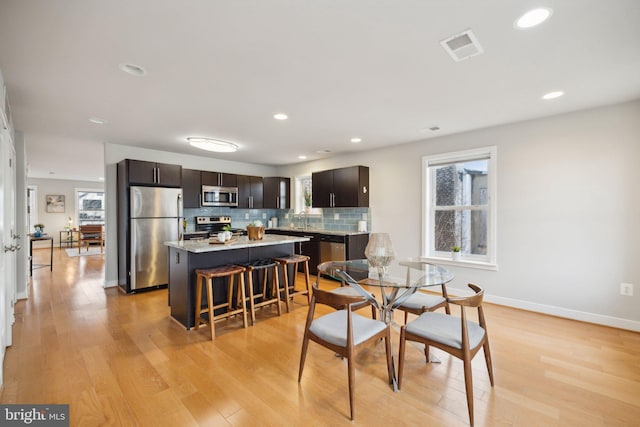 dining area featuring a healthy amount of sunlight and light wood-type flooring