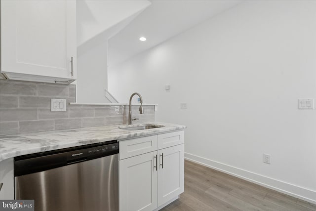 kitchen with dishwasher, white cabinetry, light stone countertops, and sink