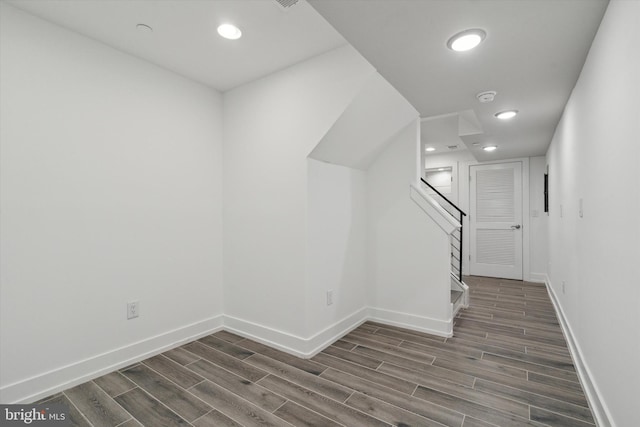 staircase with hardwood / wood-style floors