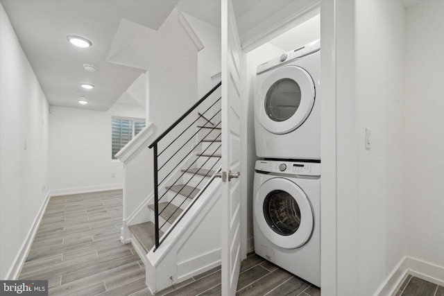 clothes washing area featuring stacked washer / dryer