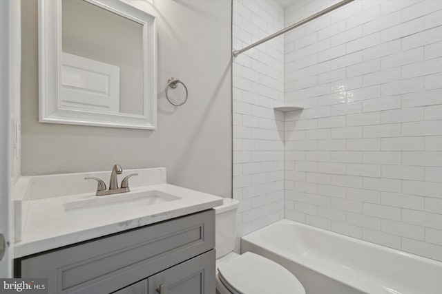 full bathroom with vanity, toilet, and tiled shower / bath