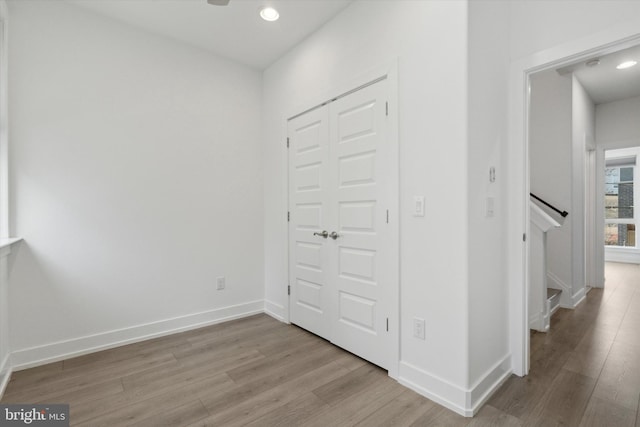 corridor with light wood-type flooring