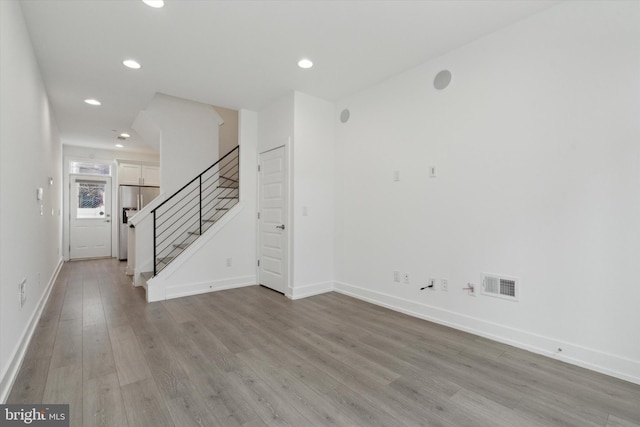 unfurnished room with light wood-type flooring