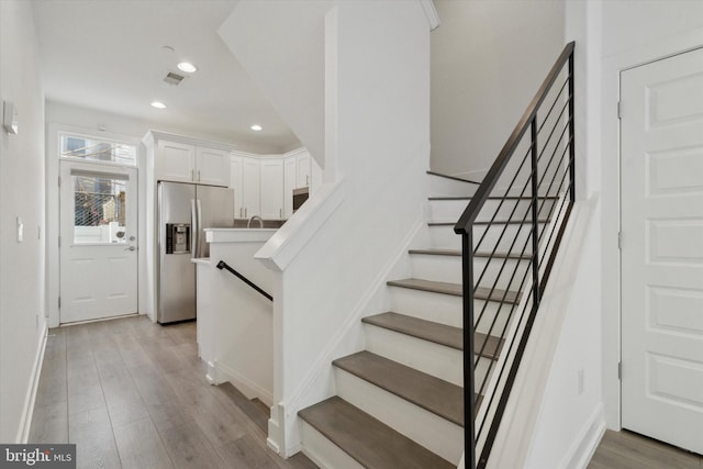 stairs with hardwood / wood-style floors