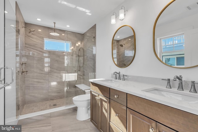 bathroom with vanity, a shower with shower door, and toilet