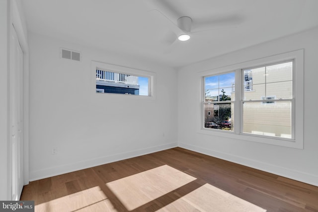 empty room featuring ceiling fan and dark hardwood / wood-style flooring