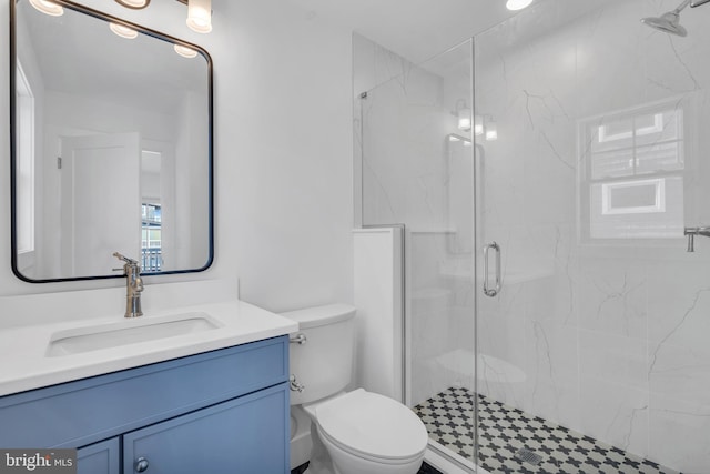 bathroom featuring vanity, toilet, and walk in shower