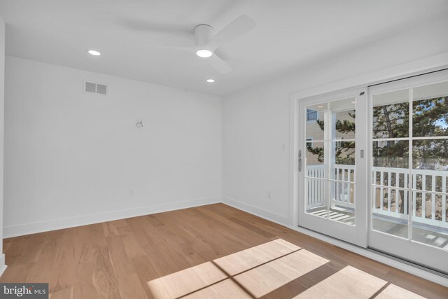 empty room featuring ceiling fan and light hardwood / wood-style floors