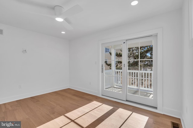 spare room with ceiling fan and light hardwood / wood-style flooring