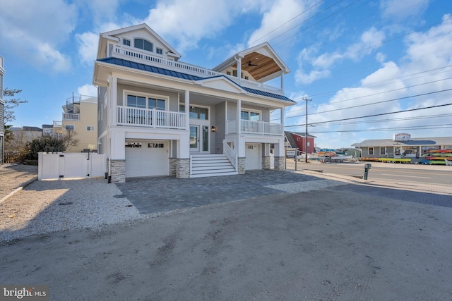 view of front of house featuring a garage and a balcony