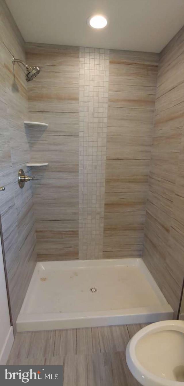 bathroom with tiled shower