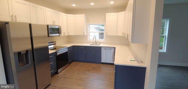 kitchen with white cabinets, stainless steel appliances, and sink