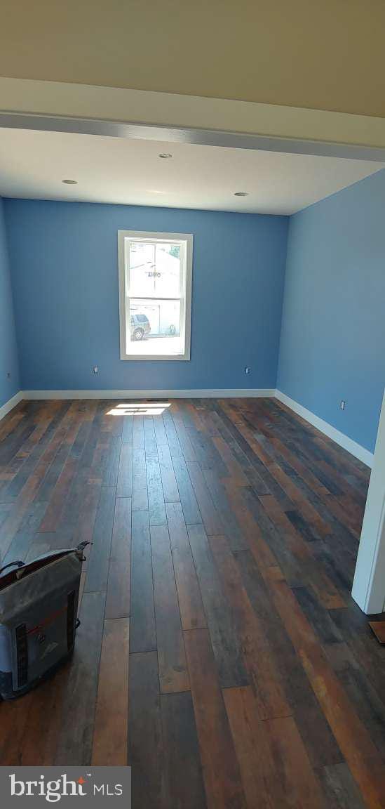 unfurnished room featuring dark hardwood / wood-style flooring