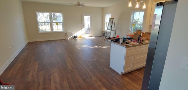 kitchen with ceiling fan, hanging light fixtures, white cabinets, and dark wood-type flooring