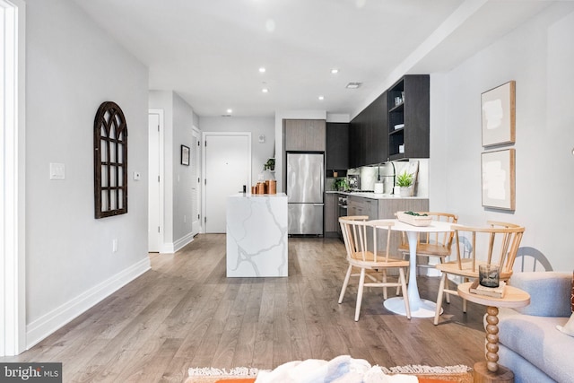 dining area featuring light wood-type flooring