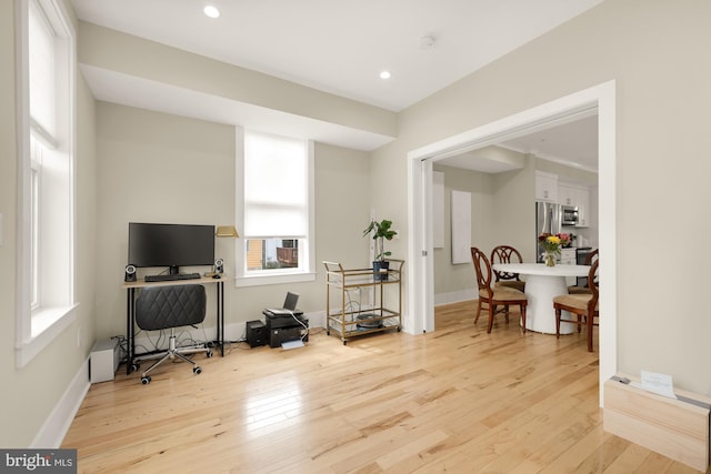 office with light hardwood / wood-style flooring