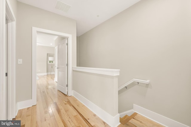 hall with hardwood / wood-style flooring