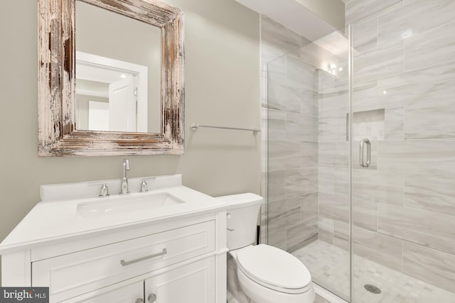 bathroom with vanity, toilet, and walk in shower