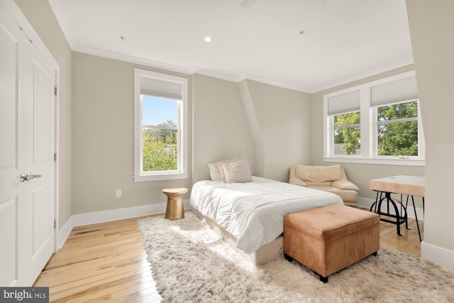 bedroom featuring light hardwood / wood-style floors and crown molding