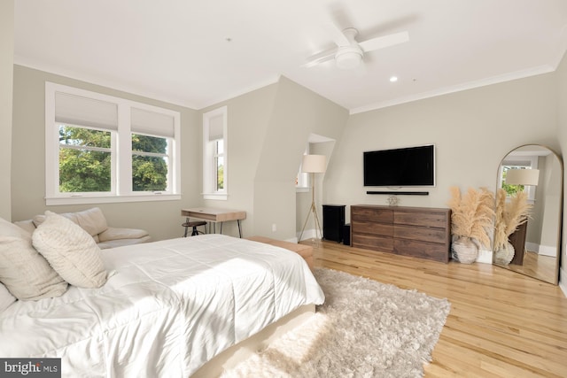 bedroom featuring ceiling fan, hardwood / wood-style floors, and ornamental molding