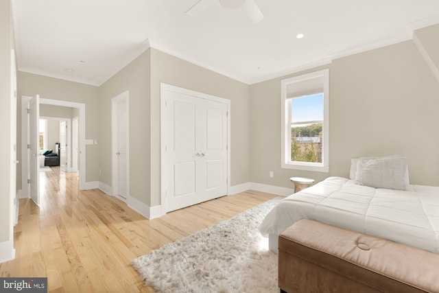 bedroom featuring a closet, ceiling fan, crown molding, and light hardwood / wood-style floors