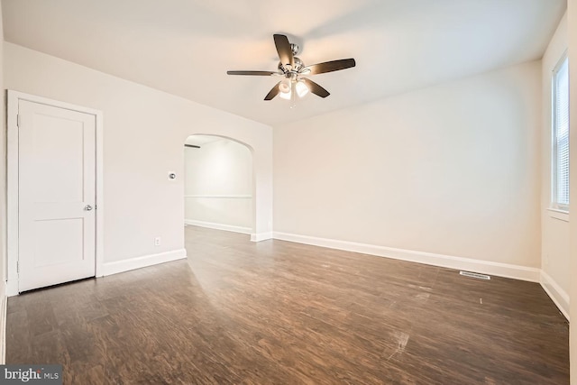 unfurnished room featuring dark hardwood / wood-style flooring, ceiling fan, and a healthy amount of sunlight