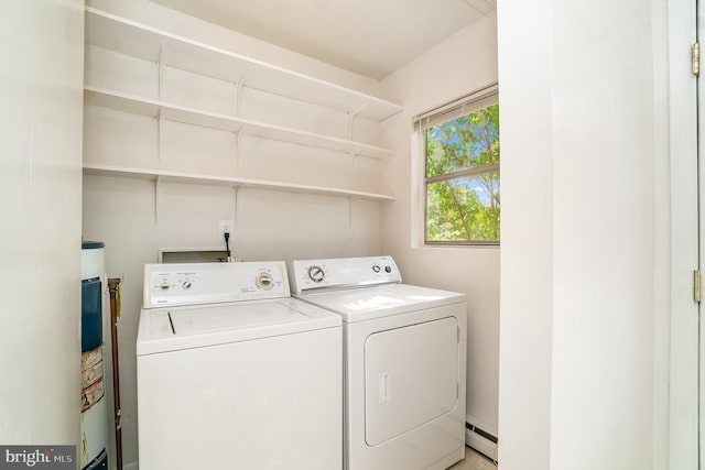 washroom featuring a baseboard heating unit and washing machine and clothes dryer