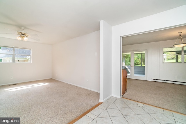 carpeted empty room with french doors, baseboard heating, and ceiling fan