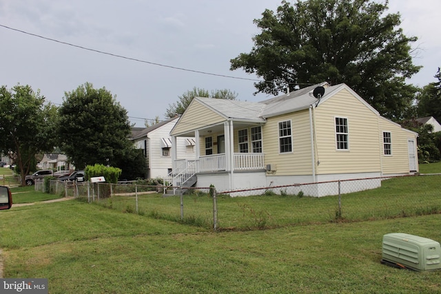 view of front of house with covered porch and a front yard