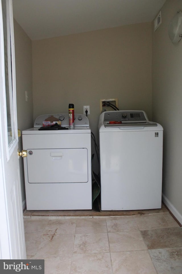 washroom with separate washer and dryer