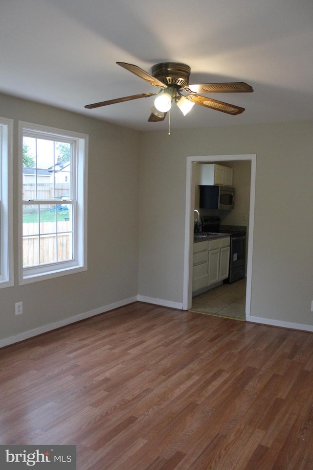 empty room featuring ceiling fan and light wood-type flooring