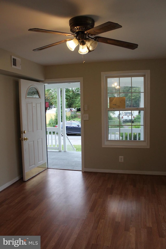 foyer with ceiling fan and dark wood-type flooring