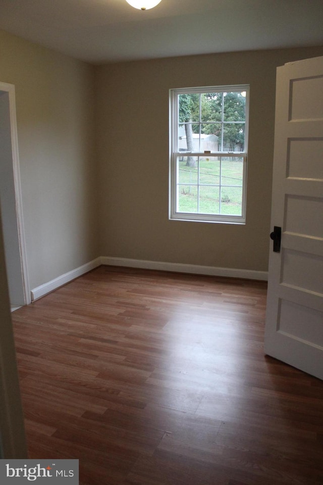 unfurnished room featuring wood-type flooring