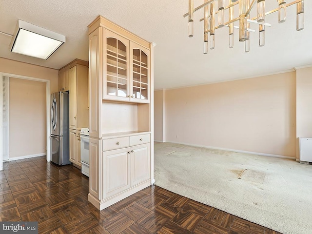 kitchen featuring decorative light fixtures, white range, stainless steel refrigerator, and dark parquet floors