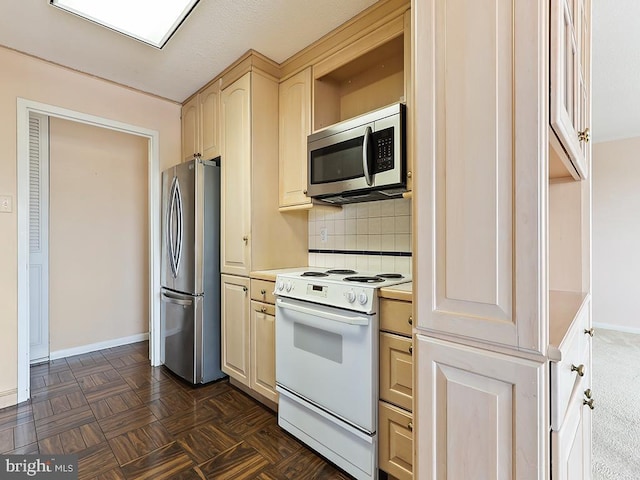 kitchen featuring backsplash, light brown cabinetry, and stainless steel appliances