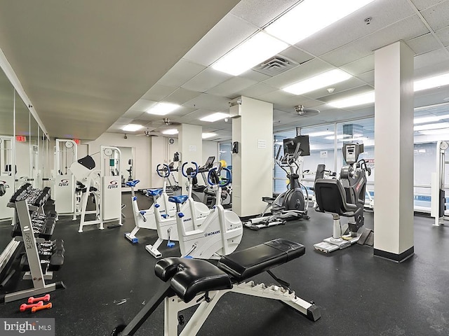 gym with a paneled ceiling