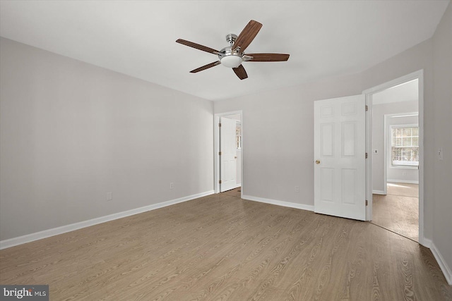 unfurnished bedroom featuring a ceiling fan, baseboards, and wood finished floors