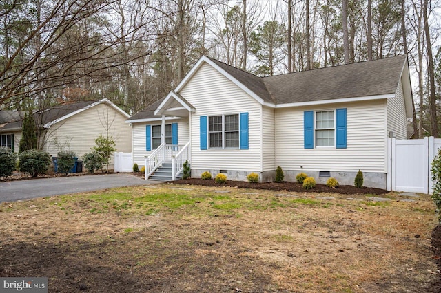 ranch-style home with crawl space, driveway, fence, and roof with shingles