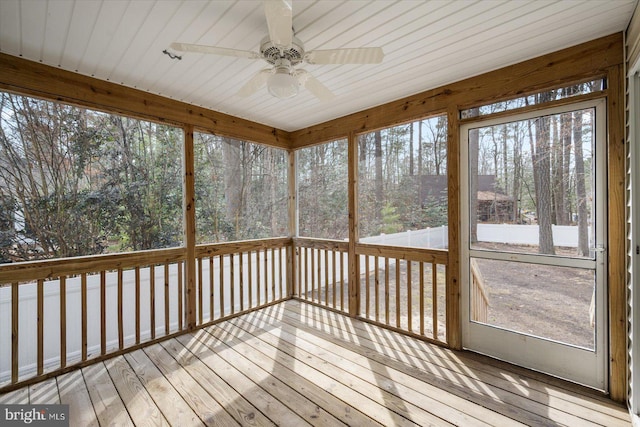 unfurnished sunroom with ceiling fan and a wealth of natural light