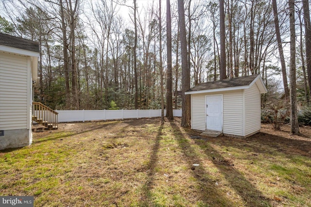 view of yard with an outdoor structure and fence