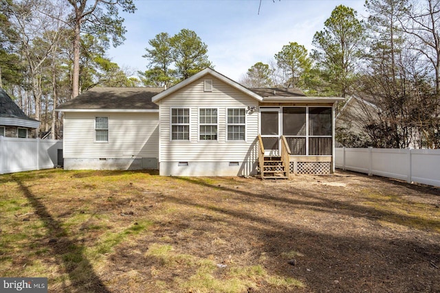 back of property with crawl space, a sunroom, a fenced backyard, and a yard