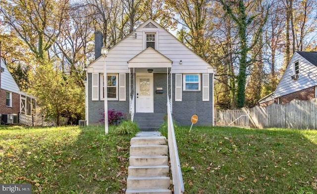 bungalow-style home featuring a front lawn