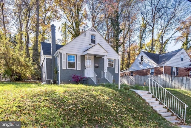 bungalow-style house featuring a front yard