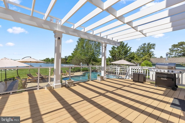 wooden terrace featuring a pergola, a water view, and area for grilling