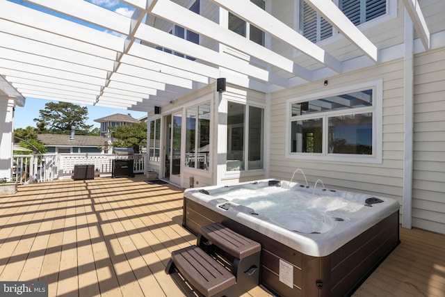 wooden terrace with an outdoor hot tub