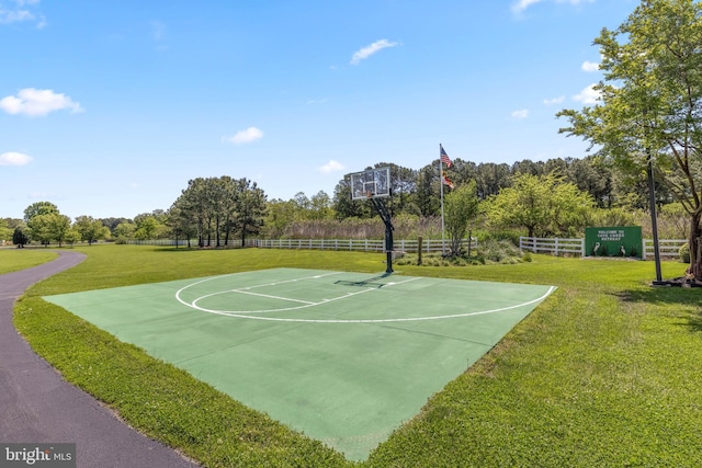 view of sport court with a yard