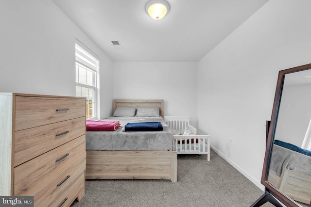 bedroom with carpet, visible vents, and baseboards